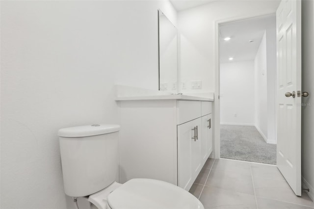 bathroom featuring tile patterned flooring, vanity, and toilet