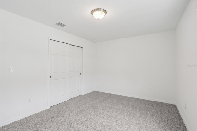 unfurnished bedroom featuring carpet floors and a closet