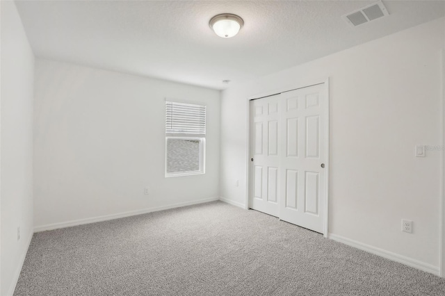 unfurnished bedroom featuring a closet and carpet floors