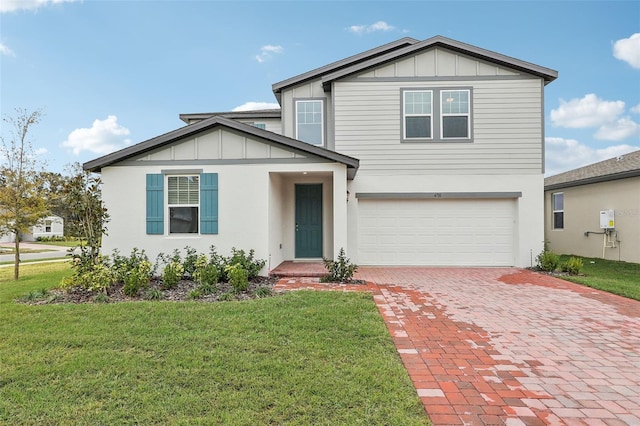 view of front of house featuring a garage and a front lawn