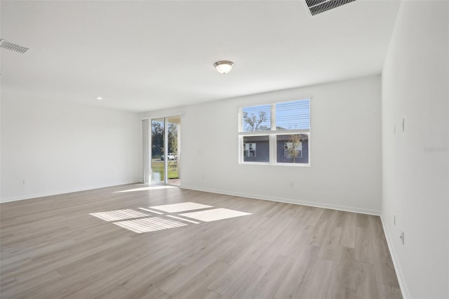 empty room with light hardwood / wood-style floors