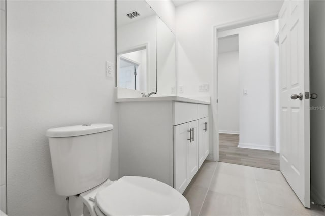 bathroom featuring hardwood / wood-style floors, vanity, and toilet