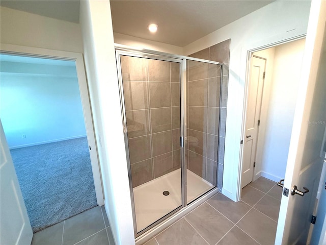 bathroom featuring tile patterned flooring and an enclosed shower