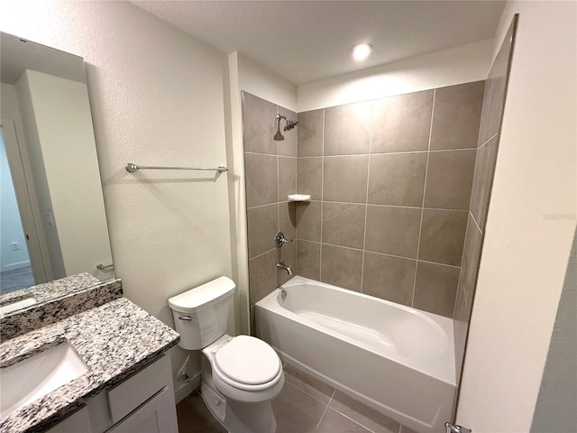 bathroom with vanity, tile patterned flooring, bathing tub / shower combination, toilet, and a textured wall