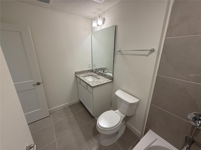 bathroom with toilet, vanity, a textured ceiling, and tile patterned floors