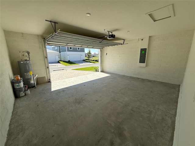 garage with concrete block wall, electric panel, a garage door opener, and electric water heater