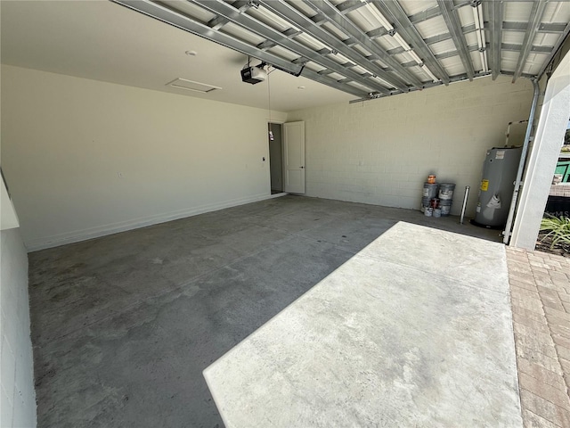 garage featuring water heater and a garage door opener