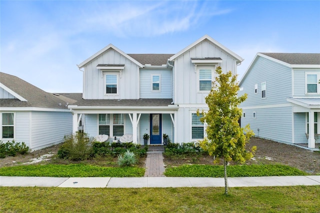 view of front of property with a porch and a front yard