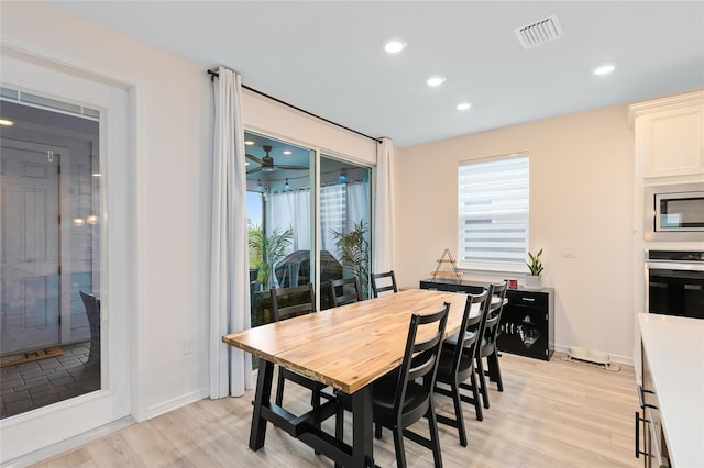 dining room featuring light hardwood / wood-style floors and ceiling fan