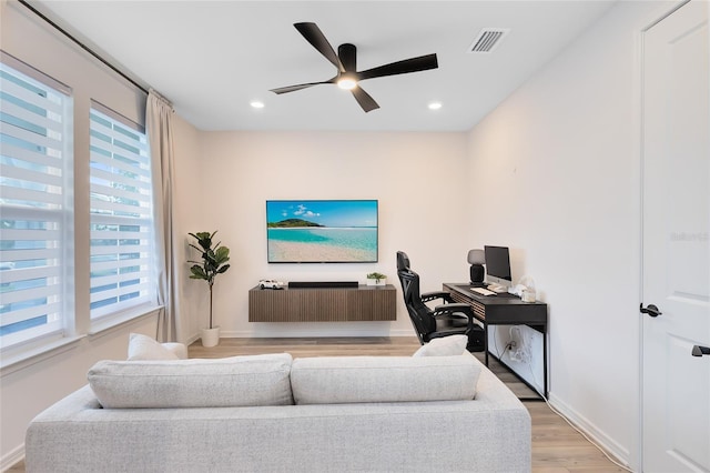 living room with ceiling fan and light wood-type flooring