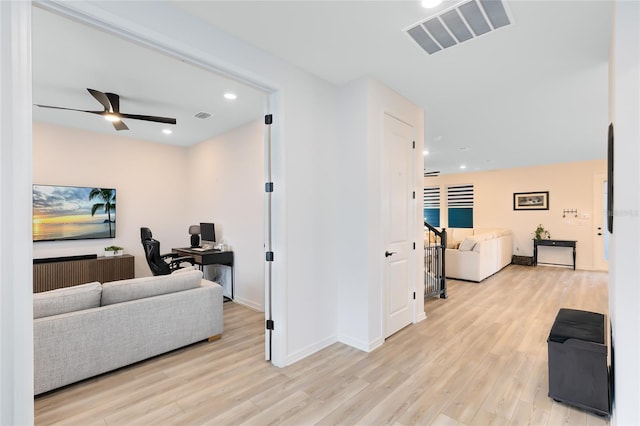 interior space with ceiling fan and light hardwood / wood-style floors