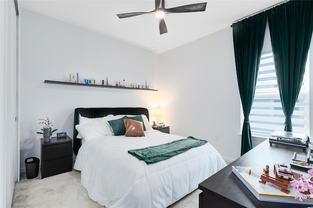 bedroom with ceiling fan and light carpet