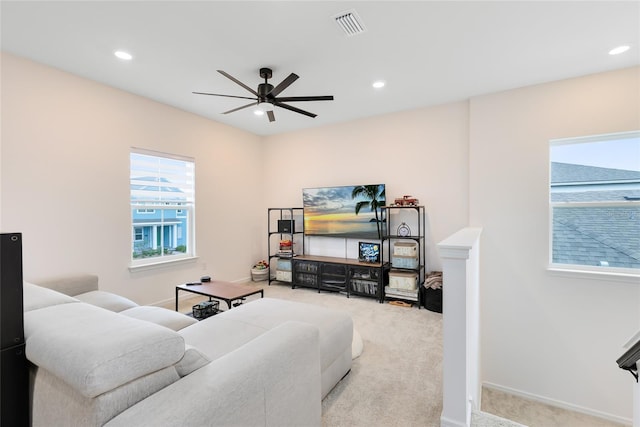 carpeted living room featuring ceiling fan