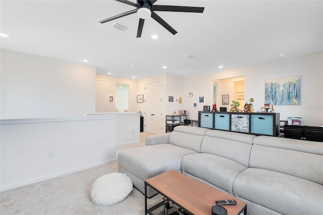 carpeted living room with ceiling fan