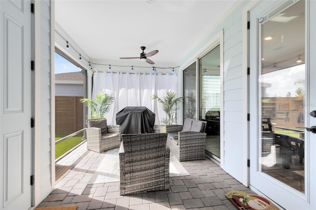 sunroom / solarium with plenty of natural light and ceiling fan