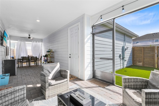 view of patio with outdoor lounge area and ceiling fan