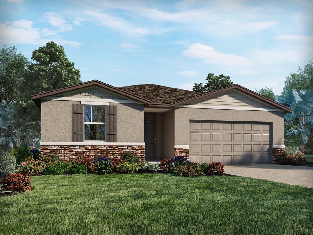 view of front facade featuring a garage and a front lawn