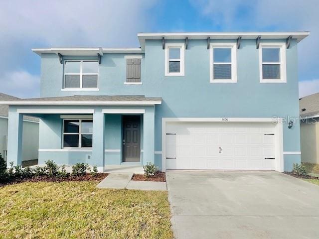 view of front of property featuring a garage and a front yard