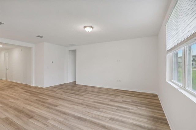 spare room featuring light hardwood / wood-style floors