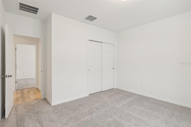 unfurnished bedroom with carpet floors and a closet