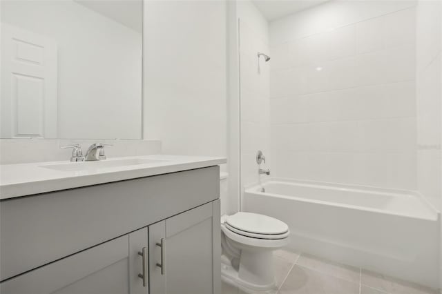 full bathroom with tile patterned flooring, vanity, tiled shower / bath combo, and toilet