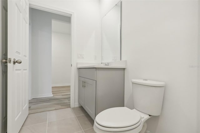 bathroom featuring tile patterned floors, vanity, and toilet