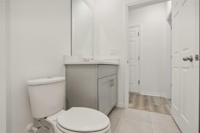 bathroom with tile patterned floors, vanity, and toilet