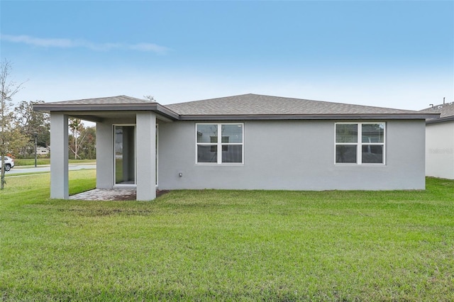 rear view of property featuring a yard