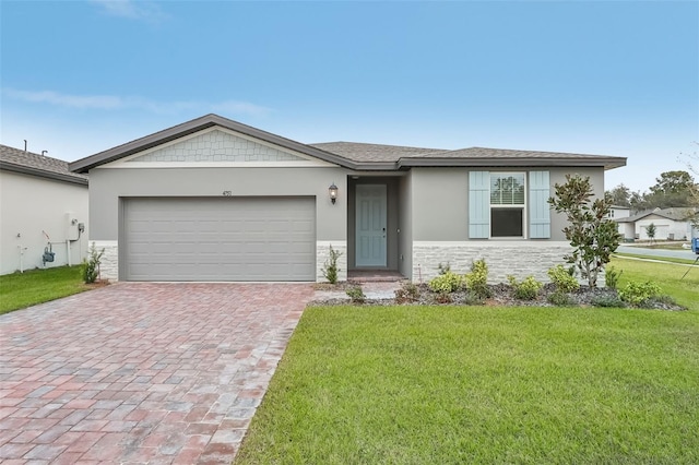 ranch-style house featuring a garage and a front lawn