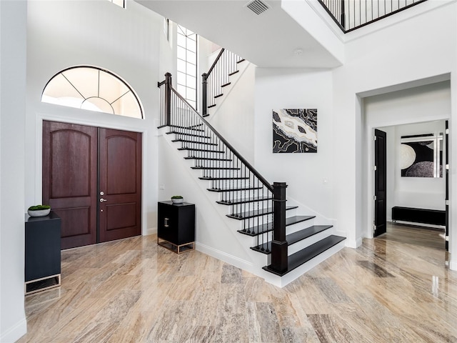 entrance foyer featuring a high ceiling and light wood-type flooring