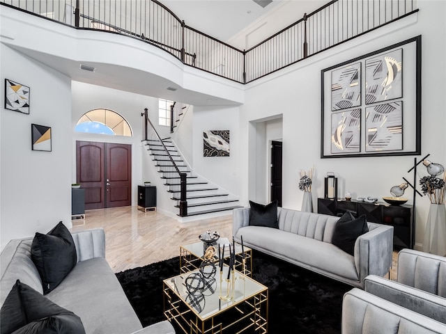 living room with a towering ceiling and hardwood / wood-style flooring