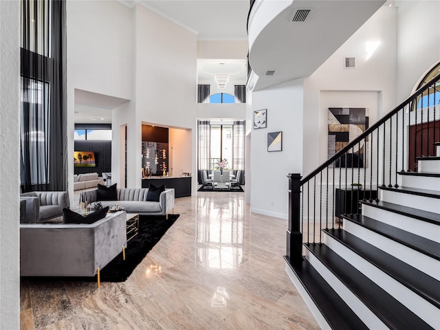 foyer featuring a high ceiling and crown molding