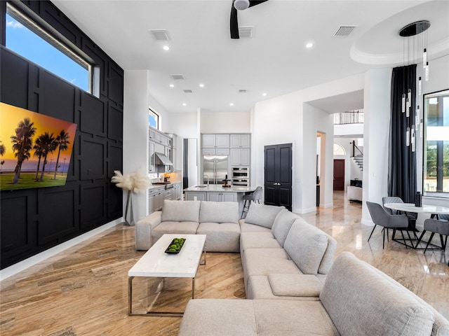 living room with light hardwood / wood-style flooring and sink