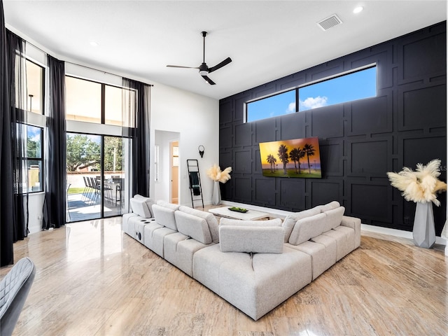 living room featuring ceiling fan and light hardwood / wood-style floors