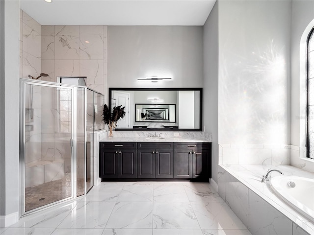 bathroom featuring vanity and independent shower and bath