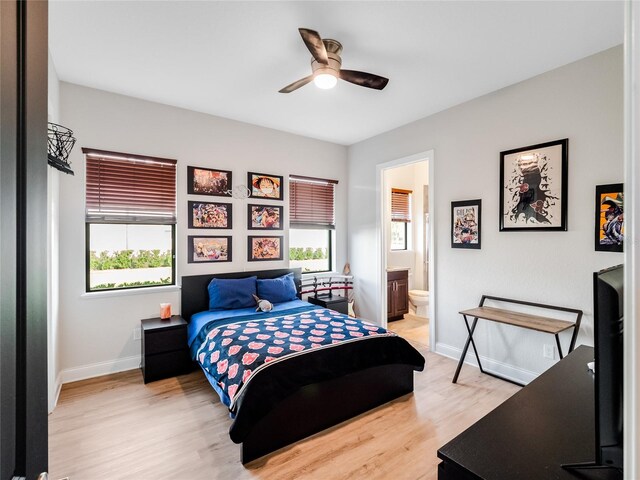 bedroom featuring light hardwood / wood-style flooring, connected bathroom, and ceiling fan