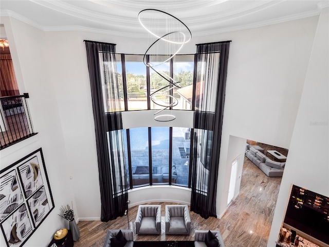 dining area with light hardwood / wood-style floors, ornamental molding, and a notable chandelier