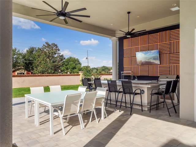 view of patio / terrace featuring exterior bar and ceiling fan