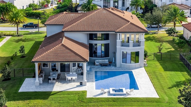 rear view of house featuring an outdoor hangout area, a yard, a patio area, and a balcony