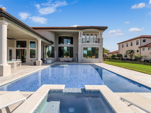 view of swimming pool featuring a lawn, a patio area, ceiling fan, and an in ground hot tub