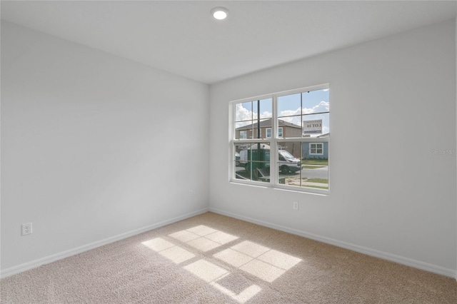 unfurnished room with light colored carpet