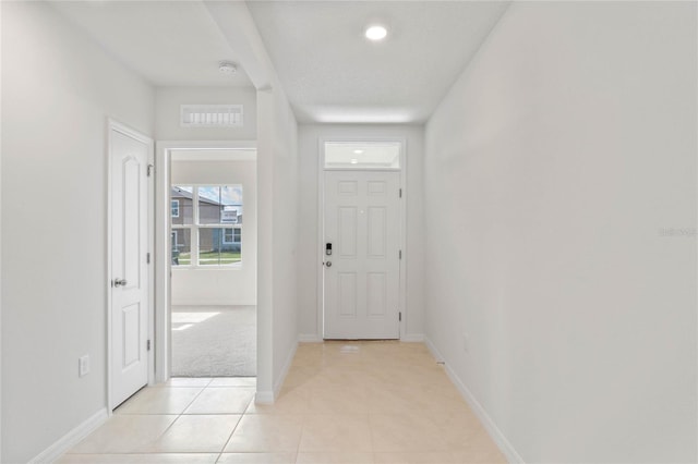 doorway to outside featuring light tile patterned floors