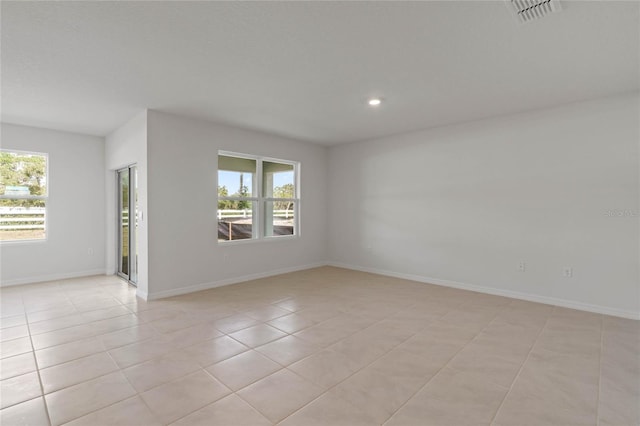 tiled spare room with a wealth of natural light