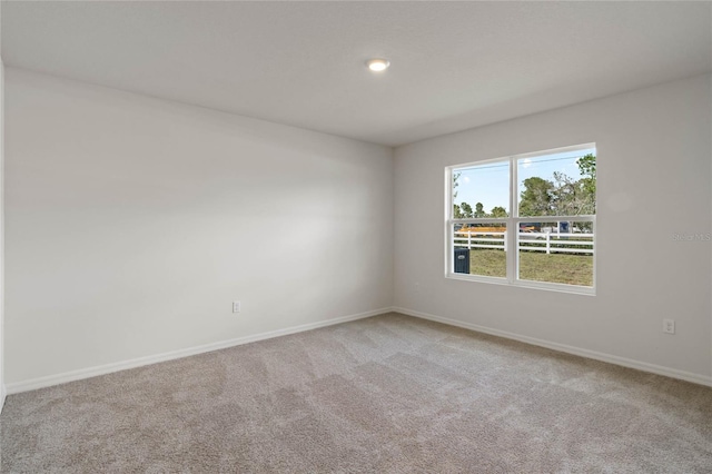 unfurnished room with light carpet