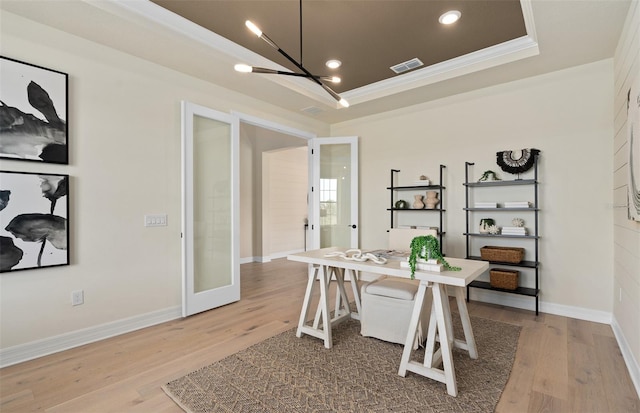 office with ornamental molding, hardwood / wood-style flooring, and french doors