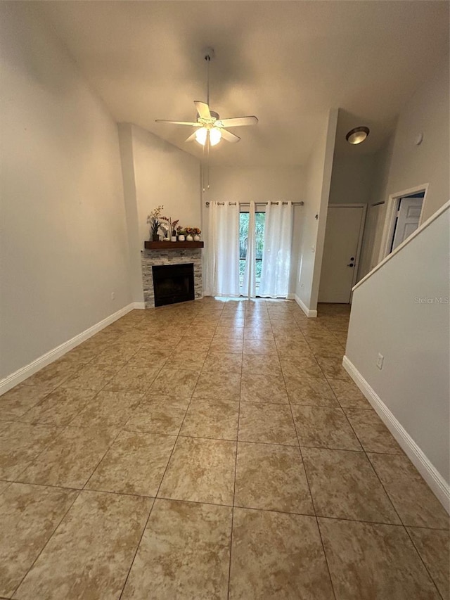 unfurnished living room featuring a fireplace, tile patterned floors, and ceiling fan