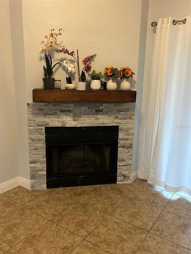 details featuring a stone fireplace and tile patterned flooring