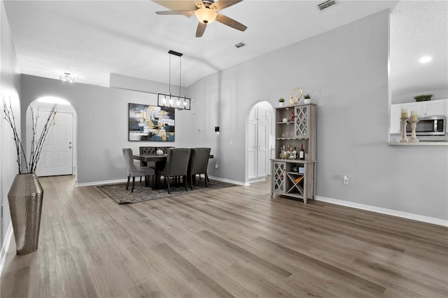 dining space with a textured ceiling, hardwood / wood-style flooring, and ceiling fan