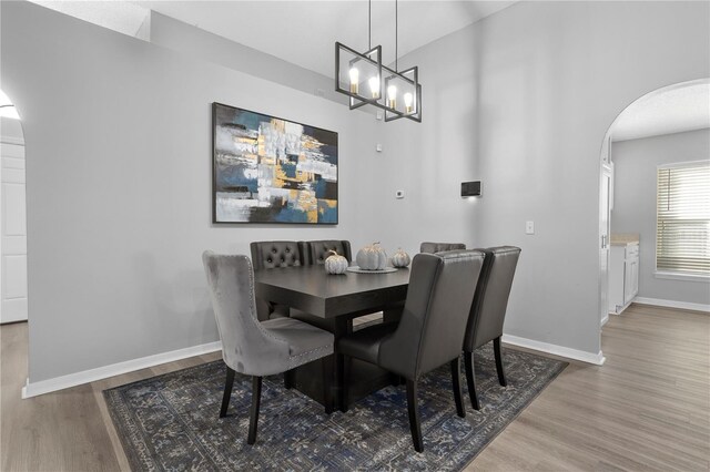 dining space with wood-type flooring