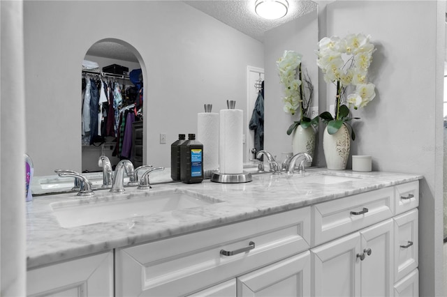 bathroom with vanity and a textured ceiling